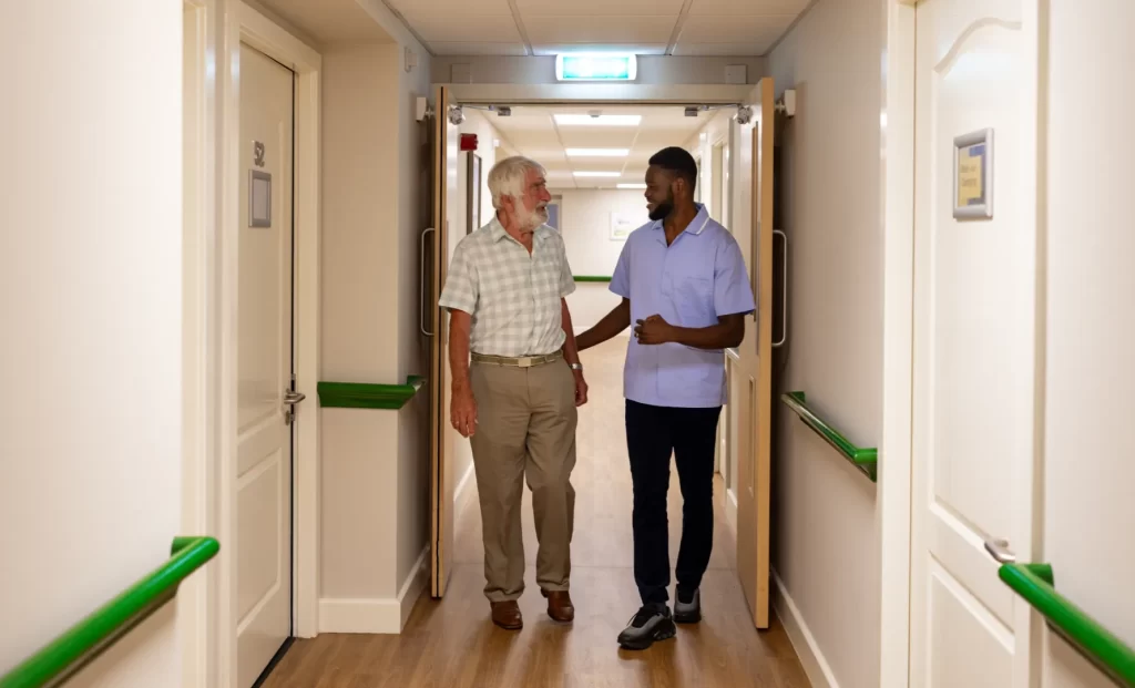 Care Home Resident and Carer in Hallway
